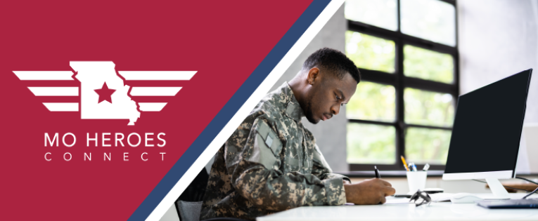 A man in uniform sitting at a computer studying something. The Mo Heroes Connect logo is situated on the left side of the image.