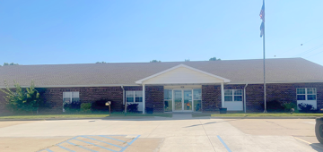 The front of the Chilicothe Job Center. It is a long building with a small gabled roof over the entrance. 